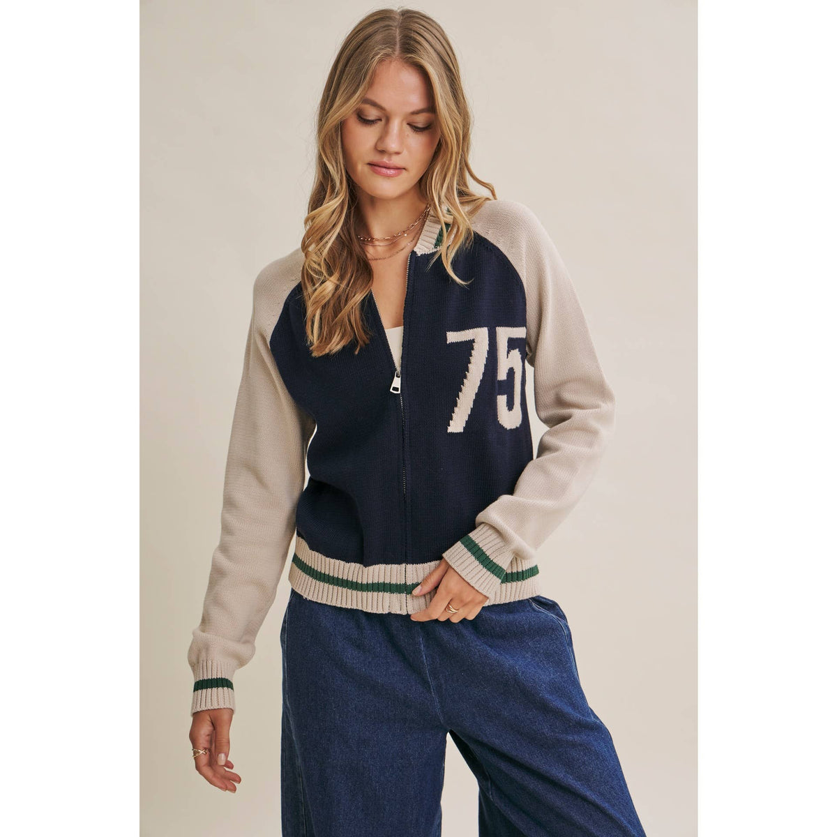 Woman's two-tone bomber knit cardigan with '75' embroidered design, zip front closure. 