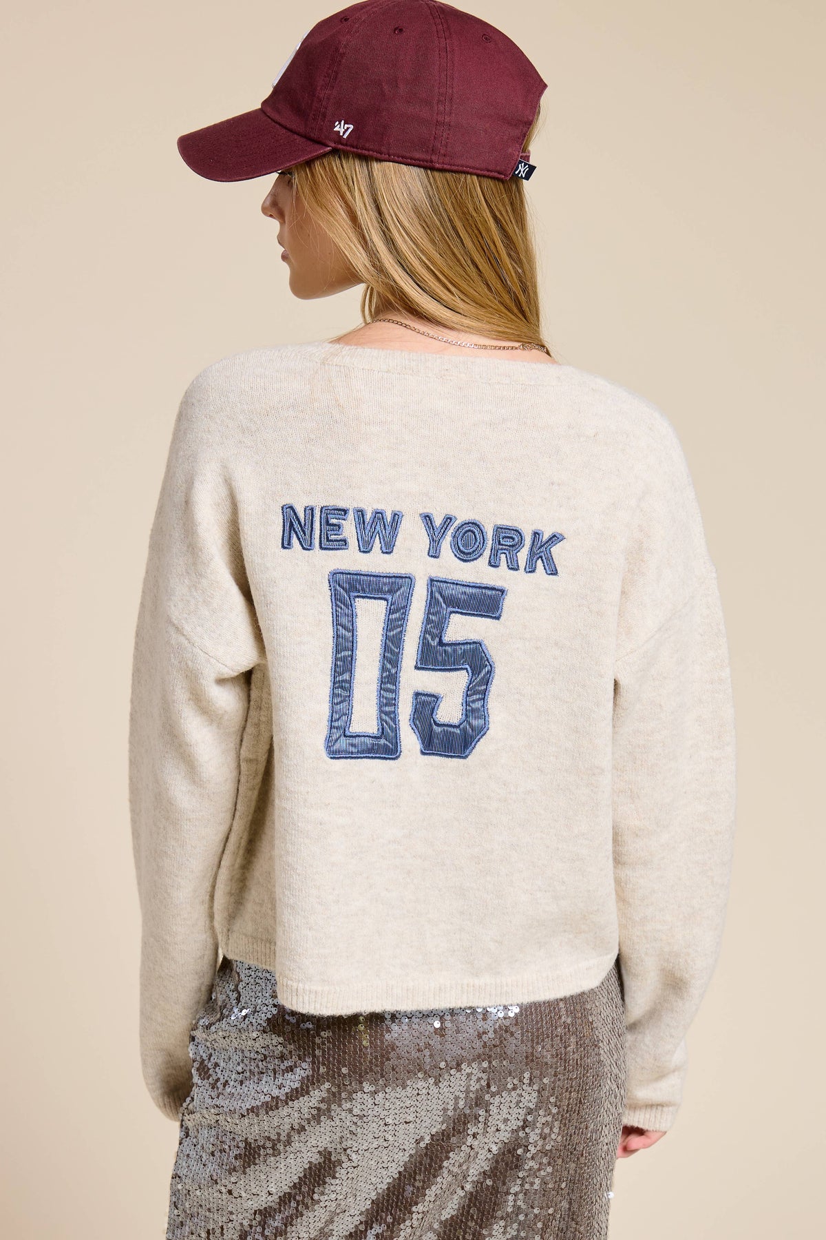 Ivory color cardigan,  "New York 05" Patchwork in blue stripe embroidered on on back, button front. Slightly cropped fit, long sleeve, soft knit fabric. Fall/Winter season. 